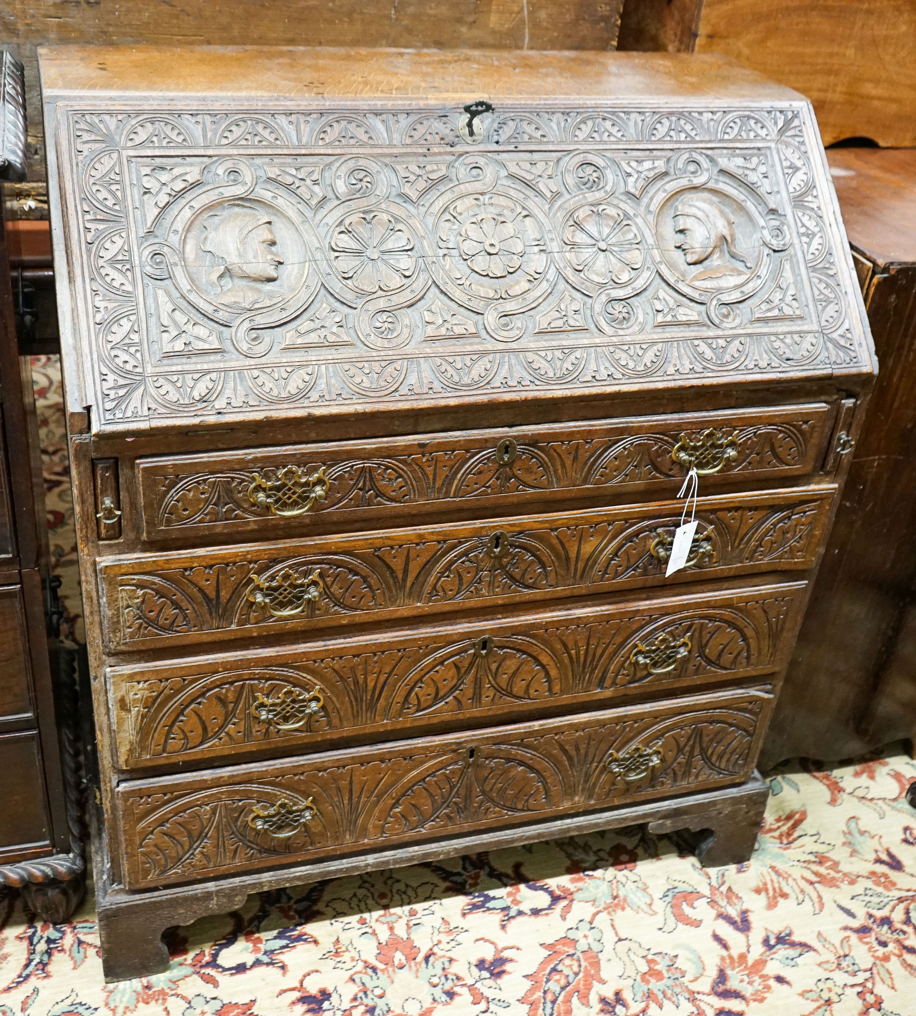 A George III later carved oak bureau, width 91cm, depth 50cm, height 106cm